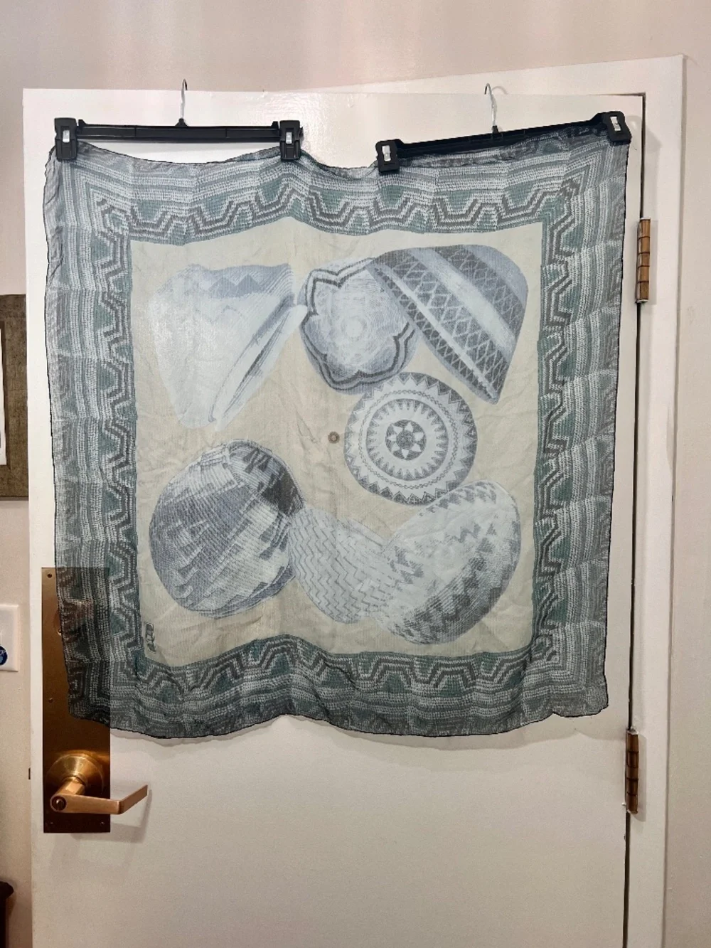 Square silk scarf with intricate graphic print of traditional woven baskets